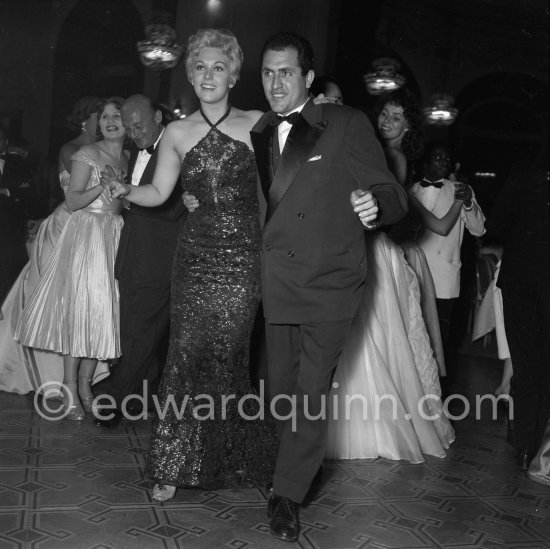 Kim Novak dancing with a local press photographer. Gala evening, Cannes Film Festival 1956. - Photo by Edward Quinn