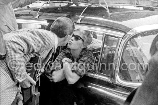 A kiss for the photographer. Edward Quinn and American actress Kim Novak. Cannes Film Festival 1956. Unknown Photographer. Car: Cadillac 1954 or 1955 Series 75 Fleetwood Sedan or Limousine. - Photo by Edward Quinn