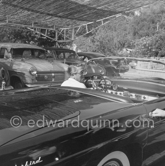 Aristotle Onassis. Nice Airport 1956. Cars: 1955 Ford Thunderbird convertible hardtop. In the background from left Hudson (taillight), 1950-55 Ford Consul, 1948-52 Austin A90 Atlantic, Renault 4CV - Photo by Edward Quinn