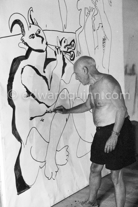 Pablo Picasso working on a bucolic pastoral scene on drawing paper which was to serve as background for the film "Le mystère Picasso". Nice, Studios de la Victorine 1955. - Photo by Edward Quinn