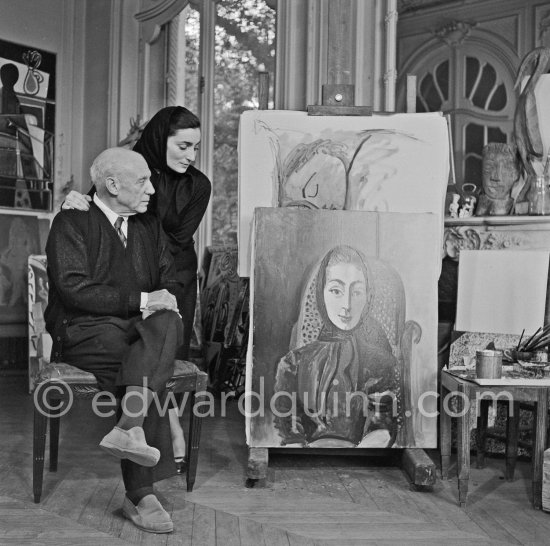 Pablo Picasso and Jacqueline with the painting "Portrait de Jacqueline au rocking-chair et à la mantille noire". La Californie, Cannes 1955. - Photo by Edward Quinn