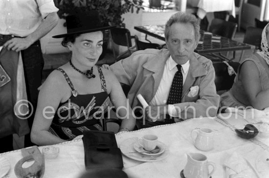 Jacqueline (with a brooch by Pablo Picasso) and Jean Cocteau at lunch at restaurant Le Vallauris given for his friends by Pablo Picasso before the bullfight in his honor. Vallauris 1955. - Photo by Edward Quinn