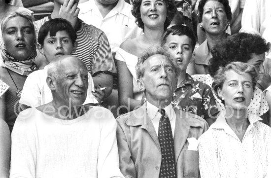 On the grandstand of a bullfight put on in Pablo Picasso\'s honor. From left: Jacqueline, Pablo Picasso, Jean Cocteau. Behind them Maya Picasso, Claude Picasso and Gérard Sassier. Vallauris 1955. - Photo by Edward Quinn