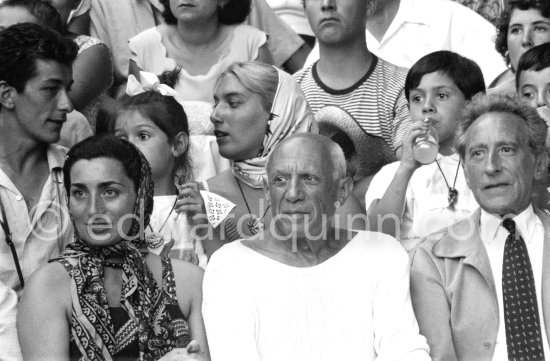On the grandstand of a bullfight put on in Pablo Picasso\'s honor. From left: Jacqueline, Pablo Picasso, Jean Cocteau. Behind them Paloma Picasso, Maya Picasso and Claude Picasso. Vallauris 1955. - Photo by Edward Quinn