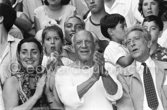 On the grandstand of a bullfight put on in Pablo Picasso\'s honor. From left: Jacqueline, Pablo Picasso, Jean Cocteau. Behind them Paloma Picasso, Maya Picasso and Claude Picasso. Vallauris 1955. - Photo by Edward Quinn