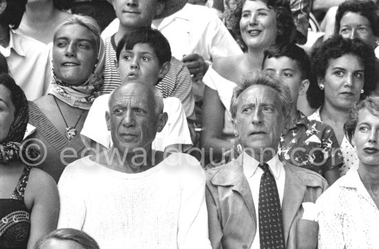 On the grandstand of a bullfight put on in Pablo Picasso\'s honor. From left: Jacqueline, Pablo Picasso, Jean Cocteau. Behind them Maya Picasso, Claude Picasso, Gérard and Inès Sassier. Vallauris 1955. - Photo by Edward Quinn