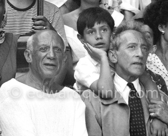 On the grandstand of a bullfight put on in Pablo Picasso\'s honor. Pablo Picasso and Jean Cocteau. Behind them Claude Picasso. Vallauris 1955. - Photo by Edward Quinn