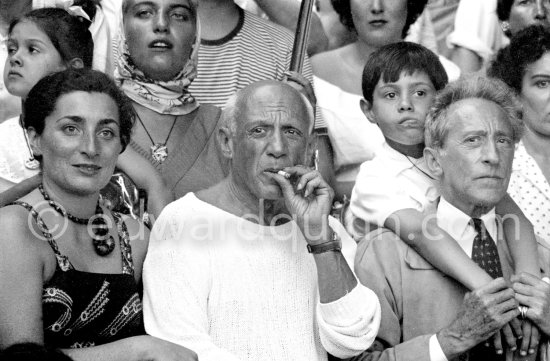 On the grandstand of a bullfight put on in Pablo Picasso\'s honor. On the left of Picasso Jacqueline, on the right Jean Cocteau, Inès Sassier, Pablo Picasso\'s housekeeper, behind Picasso his children Paloma Picasso, Maya Picasso and Claude Picasso. Vallauris 1955. - Photo by Edward Quinn