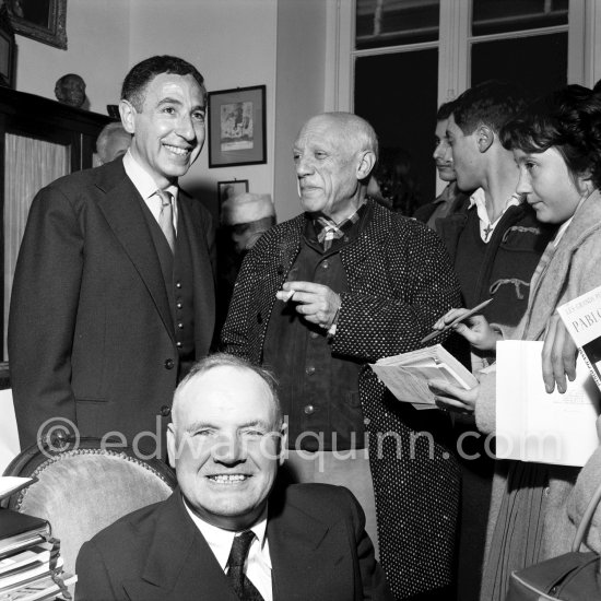 Pablo Picasso at a private viewing of his book illustrations in the Matarasso gallery in Nice. With André Verdet and Maurice Thorez,. "Pablo Picasso. Un Demi-Siècle de Livres Illustrés". Galerie H. Matarasso. 21.12.1956-31.1.1957. Nice 1956. - Photo by Edward Quinn
