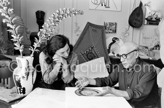 Pablo Picasso and Jacqueline viewing a book about Bernard Palissy, French potter of the 16th century. La Californie, Cannes 1957. - Photo by Edward Quinn