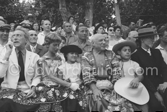 Local Corrida. Jean Cocteau, behind him Javier Vilató and Paul Derigon, the mayor of Vallauris, Francine Weisweiller, Paloma Picasso, Pablo Picasso, Claude Picasso, right French lady bullfighter Pierrette Le Bourdiec. Vallauris 1957. - Photo by Edward Quinn