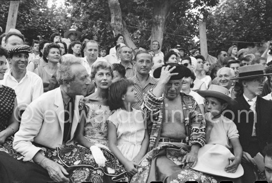 Local Corrida. Javier Vilató, Jean Cocteau, Francine Weisweiller, Paloma Picasso, Pablo Picasso, Claude Picasso, French lady bullfighter Pierrette Le Bourdiec. Vallauris 1957. - Photo by Edward Quinn