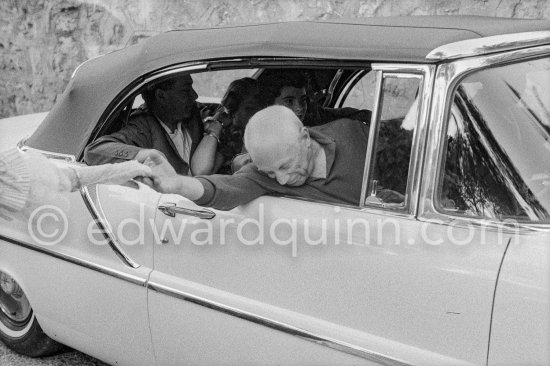 Pablo Picasso saying good-bye to Francine Weisweiller, in his Lincoln Premier Convertible 1957 driven by chauffeur Marcel. Jacqueline, Catherine Hutin, Renato Guttuso, during filming of "Le Testament d’Orphée". Saint-Jean-Cap-Ferrat 1959. - Photo by Edward Quinn