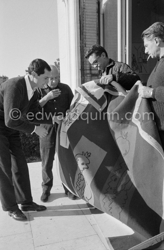 Pablo Picasso discussing with the expert Pierre Baudouin the project for a tapestry designed by him. Luis Miguel Dominguin and at right Paulo Picasso. La Californie, Cannes 1959. - Photo by Edward Quinn