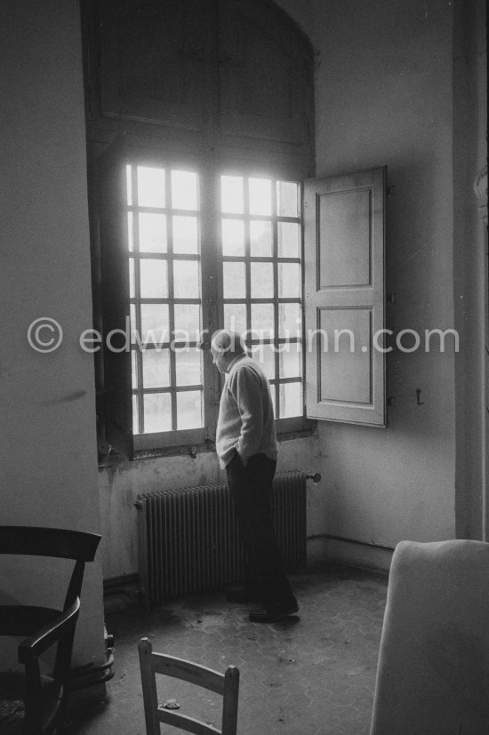 Pablo Picasso at a window of his Château de Vauvenargues 1960. - Photo by Edward Quinn
