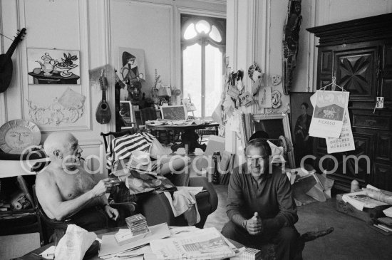 Pablo Picasso and David Douglas Duncan. On the table a pile of English newspapers reporting on his London exhibition. La Californie, Cannes 1960. - Photo by Edward Quinn