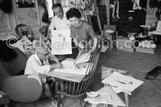 Pablo Picasso signing Rimbaud litho. With Henri Matarasso and his niece. La Californie, Cannes 1961. - Photo by Edward Quinn
