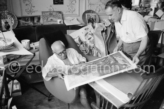 Pablo Picasso and Henri Matarasso, gallery owner and publisher, checking the etching "La Minotauromachie". La Californie, Cannes 1961. - Photo by Edward Quinn