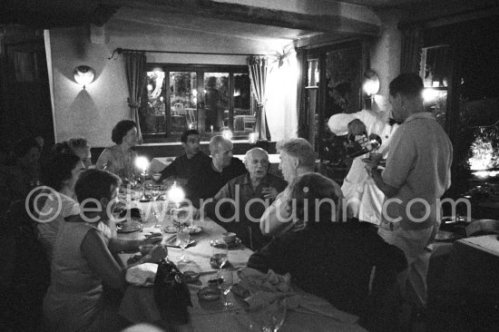 Dinner at a restaurant at Mougins 1962. From left: not yet identified person, Jacqueline, Hélène Parmelin, not yet identified person, Javier Vilató, Michel Leiris, Pablo Picasso, Edouard Pignon and from the back Louise Leiris and Marcel Duhamel. - Photo by Edward Quinn