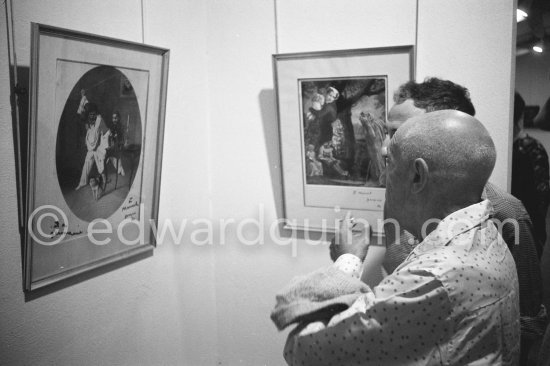 Pablo Picasso and André Verdet viewing a work by Prévert. Opening of exhibition "Images de Jacques Prévert", Château Grimaldi, Antibes, 6.8.1963. - Photo by Edward Quinn