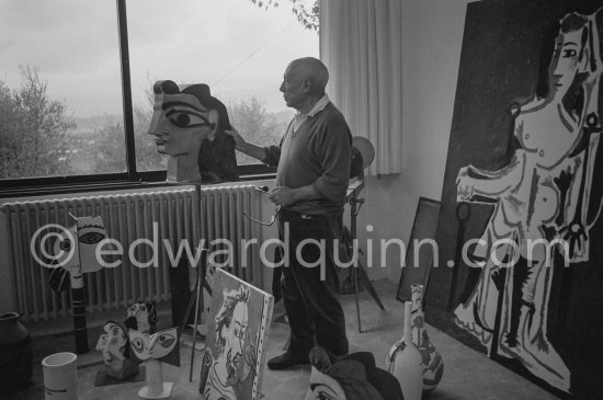 Pablo Picasso in one of his studios at Mas Notre-Dame-de-Vie, turning a three dimensional cutout head inspired by Jacqueline\'s classical features. Mougins 1964. - Photo by Edward Quinn