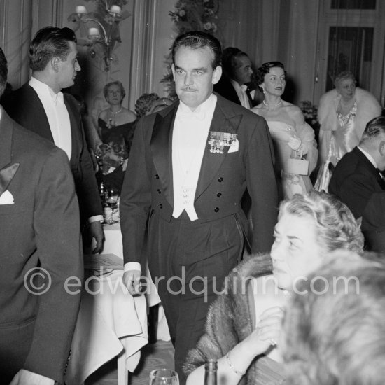 Prince Rainier. In the background his sister Princess Antoinette. This is the first time he attended the "Bal de la Rose", Monte Carlo 1955. - Photo by Edward Quinn