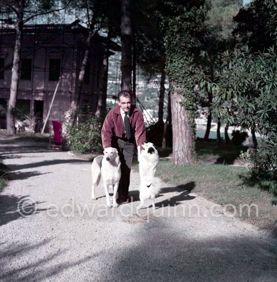 Prince Rainier of Monaco at the time he was still "the Bachelor Prince". Here he is in his bachelor hide-out, Villa Iberia, with his dogs Bella and Whiskey. Saint-Jean-Cap-Ferrat 1954. - Photo by Edward Quinn