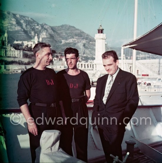 Prince Rainier on board his yacht Deo Juvante II anchored at Monaco harbor. Casino Monte Carlo in the background. Nov. 1953. - Photo by Edward Quinn