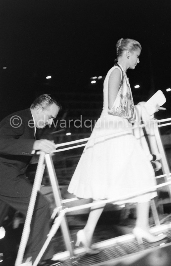 Princess Grace with arm in sling and Prince Rainier getting on Aristotle Onassis\' yacht Christina. (Grace Kelly). Monaco harbor 1959. - Photo by Edward Quinn