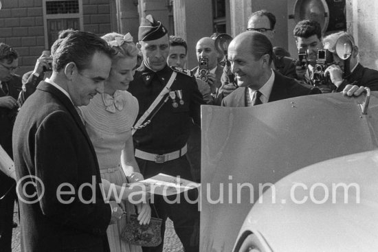 Prince Rainier and Princess Grace  meeting Monegasque people in the courtyard of the Royal Palace, here it is Louis Chiron. Grace Kelly wore a pale blue chiffon day dress by the California designer James Galanos. She accessorized the dress with a small headpiece of matching blue ribbon, white gloves and the same Morabito needlepoint bag she had carried to the Academy Award of 1955. - Photo by Edward Quinn