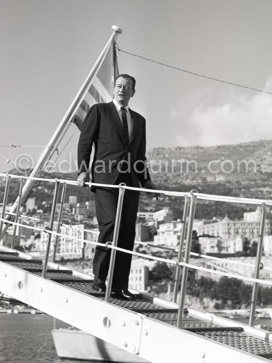 John Wayne leaving Aristotle Onassis\' luxurious yacht Christina. Monaco harbor 1955. - Photo by Edward Quinn