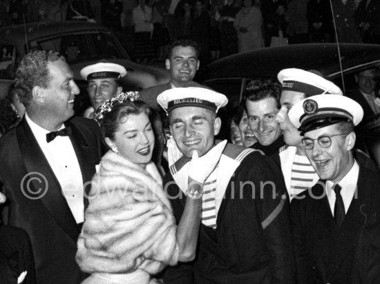 Esther Williams posing with French sailors at the entrance to the Palais du Festival Cannes 1955. On the left is her husband, Benjamin Gage. - Photo by Edward Quinn