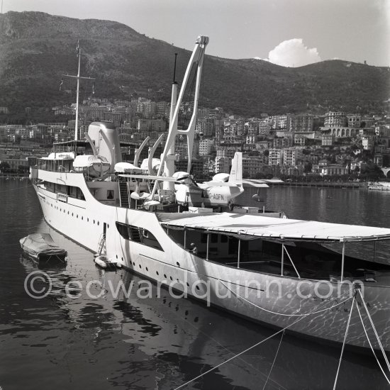 Onassis\' yacht Christina with Italian twin-engine amphibian flying boat G-AOFN Piaggio P.136-L2 C/N 195. Monaco harbor about 1955. - Photo by Edward Quinn