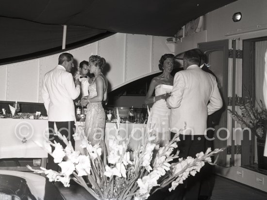 Cocktail on board the yacht Christina. Tina Onassis and Stavros Niarchos. Monaco harbor. August 1956. - Photo by Edward Quinn