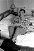 Charles Aznavour in his room at the Carlton Hotel. Cannes Film Festival 1959. - Photo by Edward Quinn