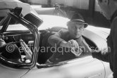 Yul Brynner and his wife were holidaying for a few days in a secret hide out in Saint-Tropez. However Brynner came out long enough to drive his new grey 1959 Mercedes-Benz 300 SL Roadster along the quayside and had a drink at one of the small restaurants. Before he left, Brynner gave a generous tip to the man who had kindly kept an eye on his car. Saint-Tropez 1959. - Photo by Edward Quinn
