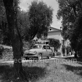 Martine Carol and Christian-Jaque, French writer-director, in the gardens of their villa "Saint Jean Farm" on the day of their wedding. Grasse 1954. Car: 1953 Simca Aronde Commerciale 1953. - Photo by Edward Quinn