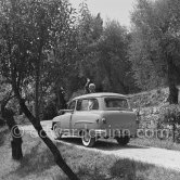 Martine Carol and Christian-Jaque, French writer-director, in the gardens of their villa "Saint Jean Farm" on the day of their wedding. Grasse 1954. Car: 1953 Simca Aronde Commerciale 1953. - Photo by Edward Quinn