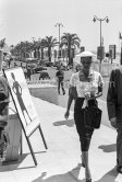 Dorothy Dandrige at "La Croisette" in Cannes, passes a poster announcing the showing of her film "Carmen Jones" at the Film Festival after a great deal of controversy with the French copyright holders of the music. Cannes 1955. - Photo by Edward Quinn