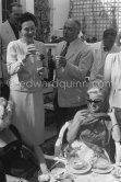 Monsieur Dissat, owner of the Hotel Montana at la Napoule, offering a glass of exceptional wine to two famous guests, on the left the french actress Arletty, on the right Diana Dors. Cannes Film Festival 1956. - Photo by Edward Quinn