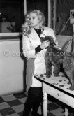 Swedish actress Anita Ekberg caressing a Poodle at an animal shelter in Nice 1960. - Photo by Edward Quinn