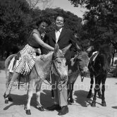 Actors Glenn Ford and Geraldine Brooks enjoy the company of two donkeys during filming of "The Green Glove". Nice 1951. - Photo by Edward Quinn