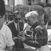 GP driver Mike Hawthorn and his film camera. Monaco Grand Prix 1955. - Photo by Edward Quinn