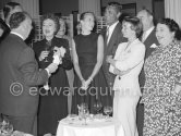 Alfred Hitchcock during a cocktail party given for the film "To Catch A Thief". Among the happily captive audience are the actors of this film (from left) Jessie Royce Landis, behind her Charles Vanel, Grace Kelly, Cary Grant, Brigitte Auber, Georgette Anys. Cannes 1954. - Photo by Edward Quinn