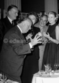 Alfred Hitchcock during a cocktail party given for the film "To Catch A Thief". Among the happily captive audience are (from left) John Williams, Jessie Royce Landis (behind Hitchcock), Charles Vanel, Grace Kelly. Cannes 1954. - Photo by Edward Quinn