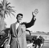 Dean Martin came to the Riviera after having entertained troops in France. Very elegantly dressed, remarked the locals, he walks along the Carlton beach. Cannes 1953. Car: Citroën Traction Avant 11BL Légère - Photo by Edward Quinn