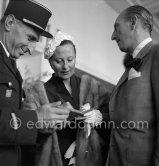A local policeman is very pleased to have his booklet signed by Michèle Morgan. Cannes Film Festival 1951. - Photo by Edward Quinn