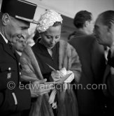 A local policeman is very pleased to have his booklet signed by Michèle Morgan. Cannes Film Festival 1951. - Photo by Edward Quinn