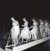 From left: Tina Onassis, actress Cyd Charisse (other ladies not yet identified) leaving the yacht Christina of Aristotle Onassis for a gala night at Monte Carlo 1957. - Photo by Edward Quinn