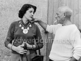 Pablo Picasso with Madame Paule de Lazerme (she had an affair with Pablo Picasso for some months) who wears a necklace designed by Pablo Picasso, made with the help of the Vallauris dentist Dr. Chatagnier. In front of the studio Le Fournas, Vallauris 1953. - Photo by Edward Quinn